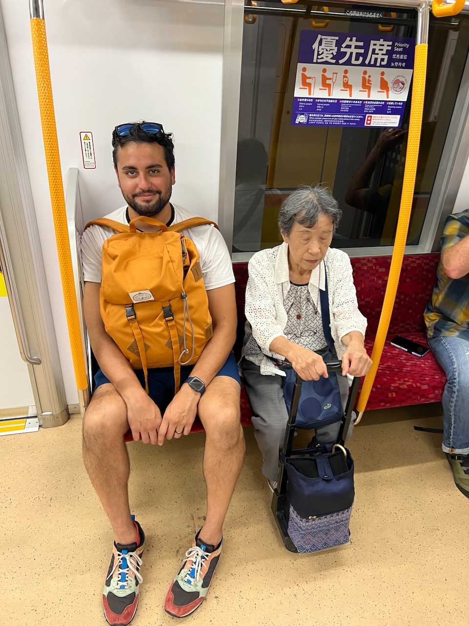 September: Charlie and his seat buddy on the Tokyo Metro